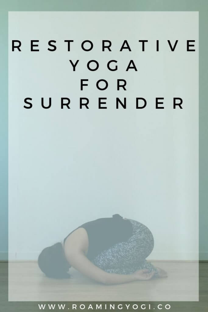 Image of a young woman in the yoga pose child’s pose, with text overlay: Restorative Yoga for Surrender. www.roamingyogi.co