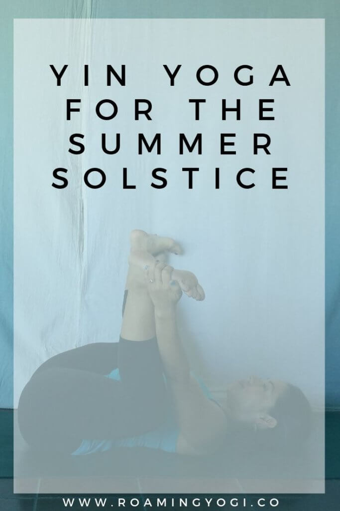 Image of a young woman in the yoga pose Happy Baby, with text overlay: Yin Yoga for the Summer Solstice. www.roamingyogi.co